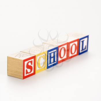 Alphabet toy building blocks spelling the word school.