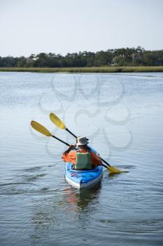 Royalty Free Photo of a Couple Paddling in a Kayak
