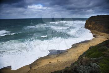 Coastline with waves and rocky shore as seen from Great Ocean Road in Australia.