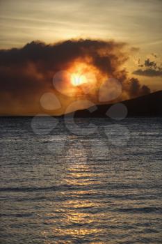 Royalty Free Photo of Dark Clouds at Sunset Over Water on Maui, Hawaii