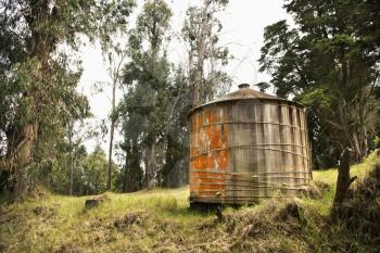 Royalty Free Photo of Round Rustic Storage Structure With Peeling Orange Paint