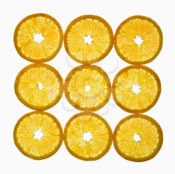 Orange slices arranged in square design on white background.