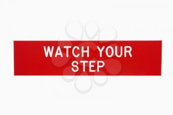 Royalty Free Photo of a Red Sign Reading Watch Your Step