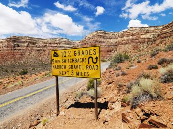 Royalty Free Photo of a Road Sign Warning Steep Grade in Mountainous Utah Landscape