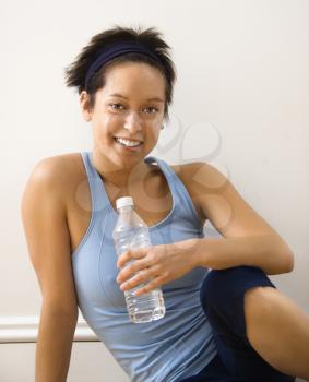 Royalty Free Photo of a Woman Sitting With a Water Bottle
