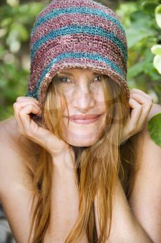 Royalty Free Photo of a Redheaded Woman Wearing a Hat