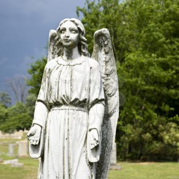 Royalty Free Photo of a Guardian Angel Statue in a Graveyard