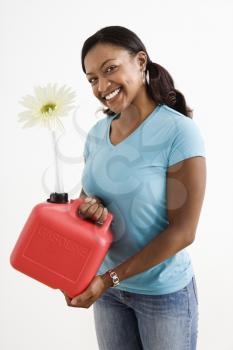 Royalty Free Photo of a Woman Holding a Gas Can With a Flower in it's Nozzle