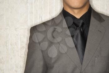 Cropped close-up of businessman's suit jacket and necktie. Horizontal format.