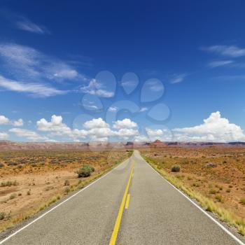 Rural State Route 261 in Utah with scenic landscape and blue sky in background. Square shot.