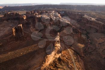 Aerial view of rocky canyons in a desert landscape. Horizontal shot.