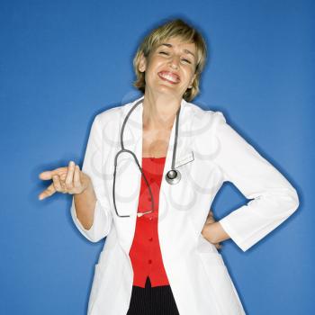 Caucasian female doctor holding out hand and smiling.