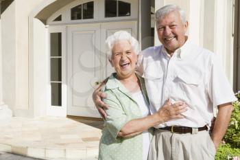 Royalty Free Photo of a Senior Couple Outside Their Home