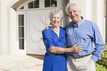 Royalty Free Photo of a Senior Couple Outside Their Home