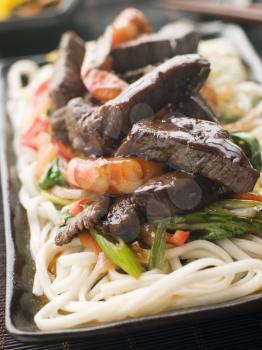 Royalty Free Photo of Teriyaki Beef Fillet and Tiger Prawns with Udon Noodles