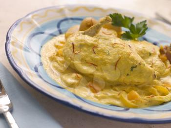 Royalty Free Photo of Chicken Breast with a Saffron and Almond Sauce