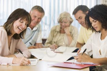 Royalty Free Photo of Five People Taking Notes at a Table