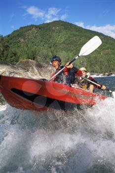 Royalty Free Photo of Two People Rowing Into Rapids