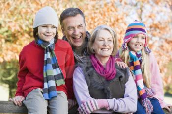 Grandparents with grandchildren outdoors at park smiling (selective focus)