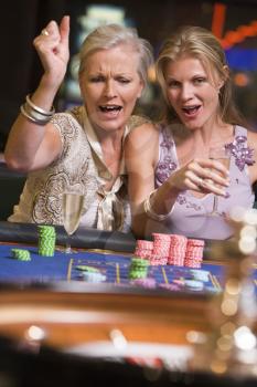 Royalty Free Photo of Two Women at a Roulette Table