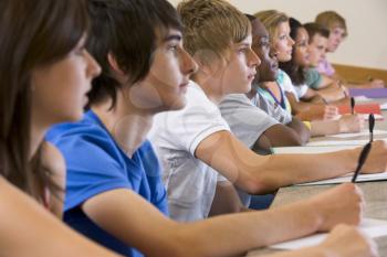 Students in class paying attention and taking notes (selective focus)