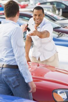 Royalty Free Photo of a Man Getting the Keys for a New Car