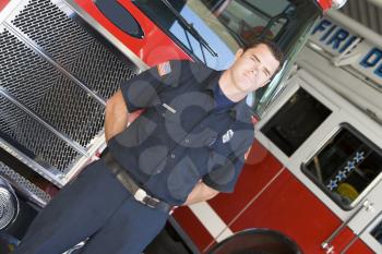 Royalty Free Photo of a Firefighter in Front of a Firetruck