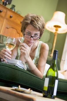 Royalty Free Photo of a Young Woman Drinking Wine and Smoking