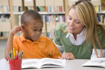 Royalty Free Clipart Image of a Student Reading in Class