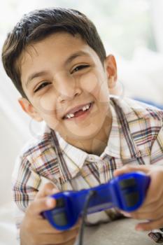 Royalty Free Photo of a Young Boy Playing Video Games