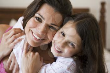 Royalty Free Photo of a Girl Hugging a Woman