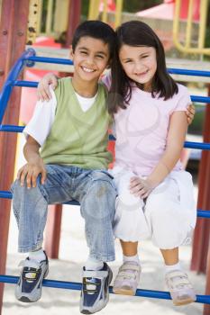 Royalty Free Photo of Two Children on Playground Equipment