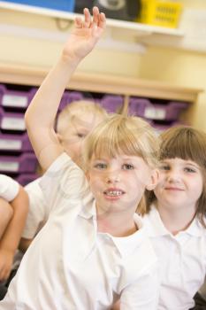 Royalty Free Photo of a Girl Raising Her Hand in Class