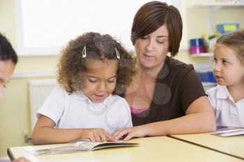 Royalty Free Photo of a Student and Teacher Reading