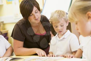 Royalty Free Photo of Students and a Teacher Reading