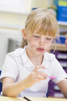 Royalty Free Photo of a Girl Counting Beads