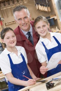 Royalty Free Photo of a Teacher and Woodworking Students