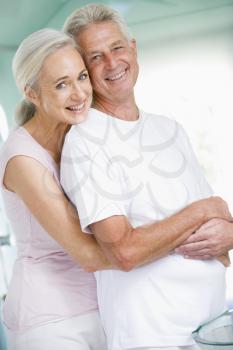 Royalty Free Photo of a Couple Embracing by a Sink