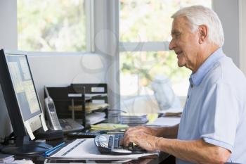Royalty Free Photo of a Man at Home on the Computer