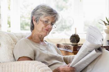 Royalty Free Photo of a Woman Reading a Newspaper