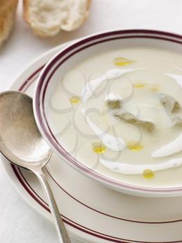 Royalty Free Photo of a Bowl of Vichyssoise with oil and Rustic Bread
