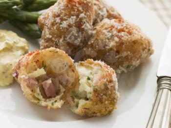 Royalty Free Photo of Ham and Cheese Beignets with Asparagus and Dijonnaise
