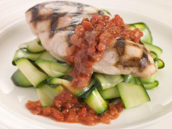 Royalty Free Photo of a Chargrilled Chicken Breast With Courgette Ribbons and Tomato Concasse