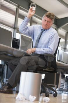 Royalty Free Photo of a Man Throwing Garbage in a Bin