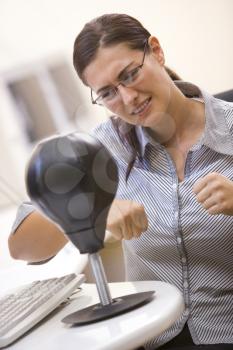 Royalty Free Photo of a Woman Punching a Bag