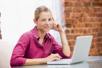 Royalty Free Photo of a Woman Sitting at a Laptop