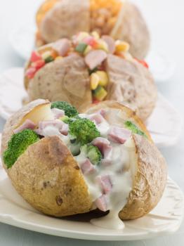 Royalty Free Photo of Baked Potatoes with a Selection of Toppings