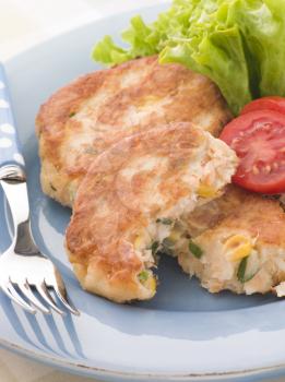 Royalty Free Photo of Cod and Salmon Fish Cakes With Corn and Salad