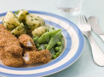 Royalty Free Photo of Chicken Goujons With Herb Buttered New Potatoes and Green Vegetables