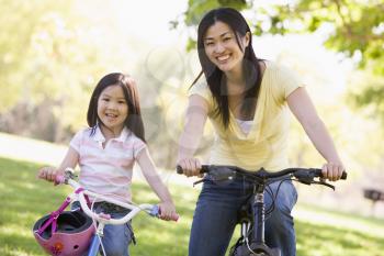 Royalty Free Photo of a Mother and Daughter on Bikes